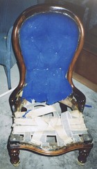 old armchair with broken cushion seat