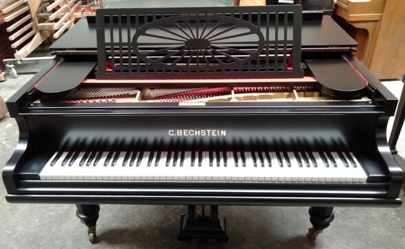 restored grand piano black french polish